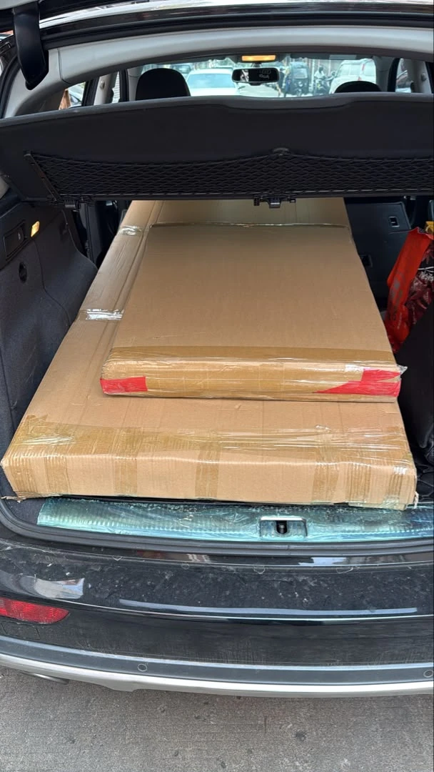 Two flat carton-packed panels at collection, with identifying labels obscured