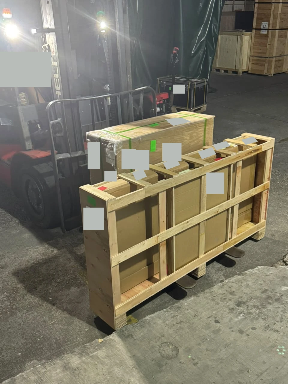 Forklift handling the framed replacement panels beside the loading vehicle