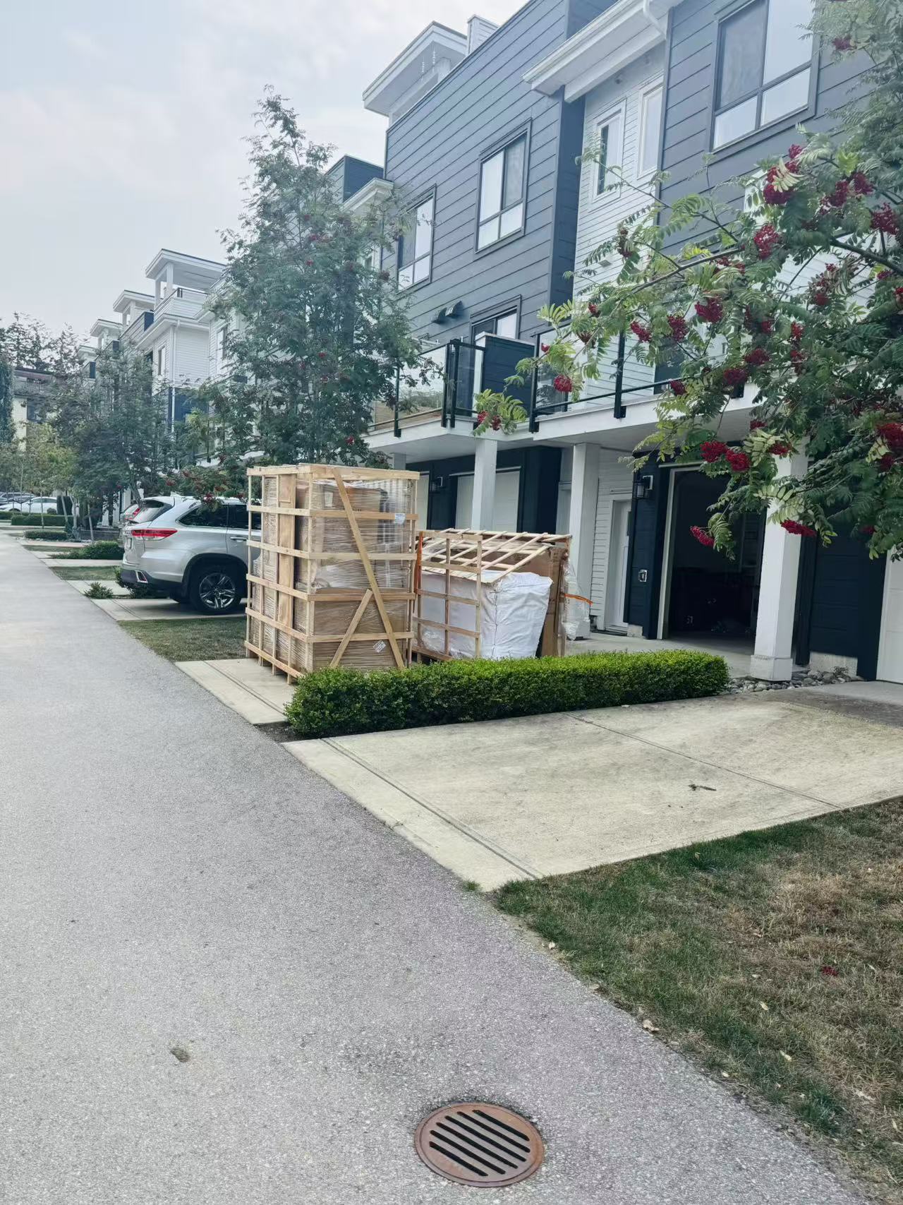 Export-crated whole-household cargo photographed at a completed Canadian residential delivery point