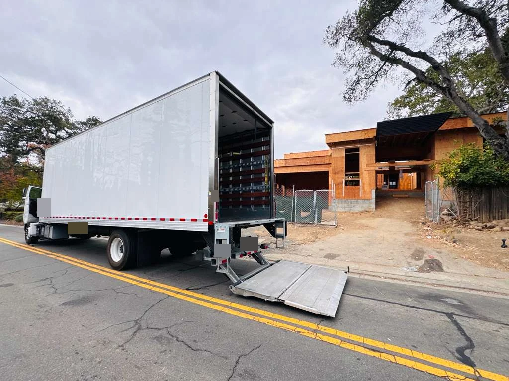 Anonymized customer-supplied photo of the delivery truck beside a U.S. residential construction site