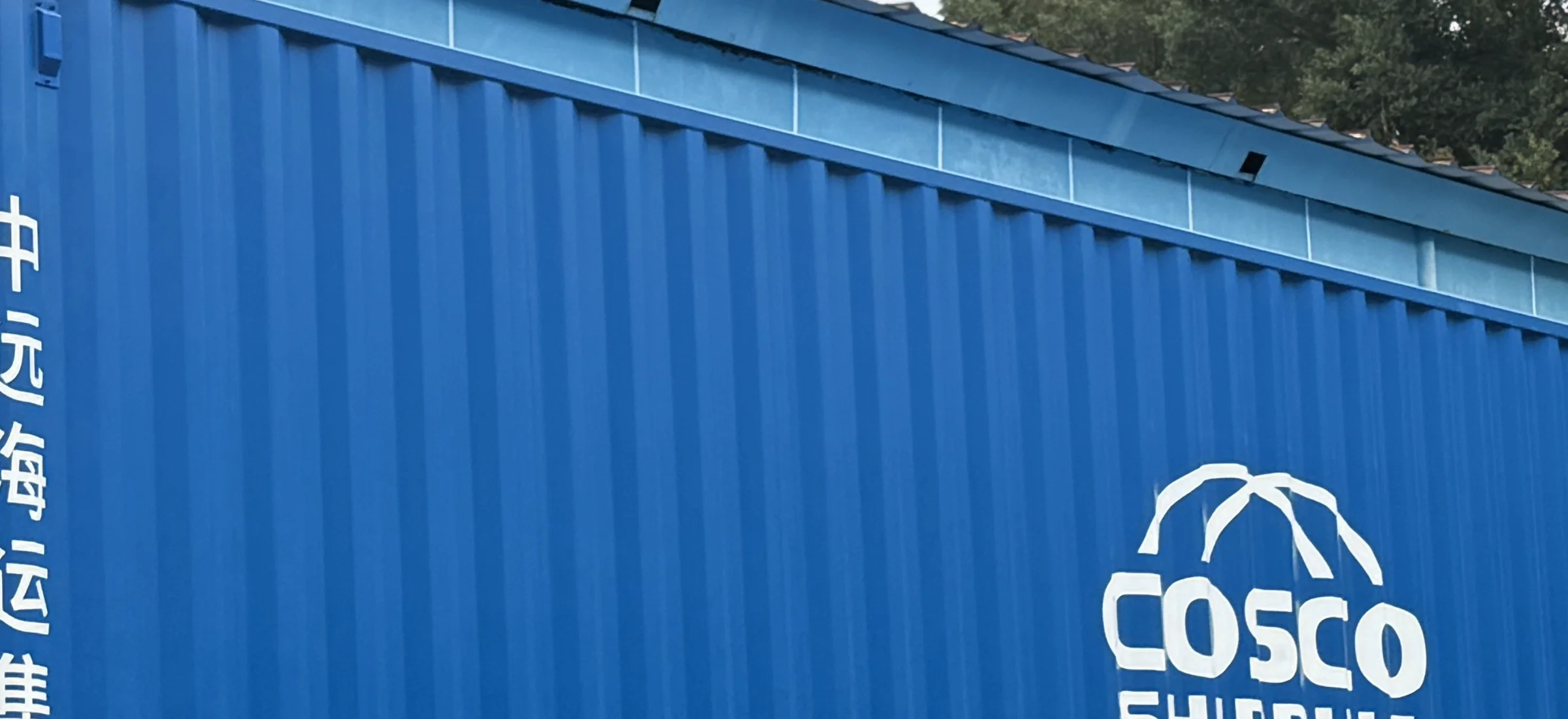 A sealed shipping container positioned at the warehouse for dispatch