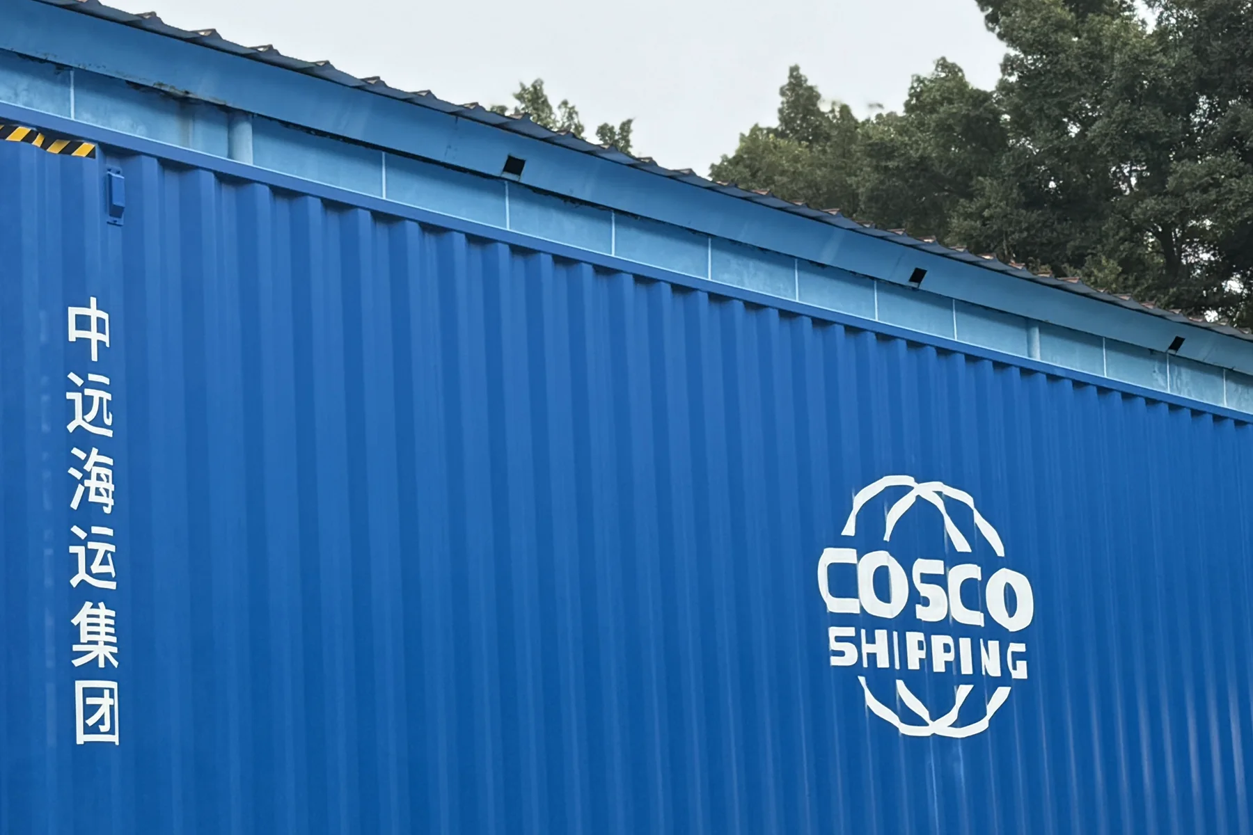 A sealed shipping container positioned for international dispatch from China