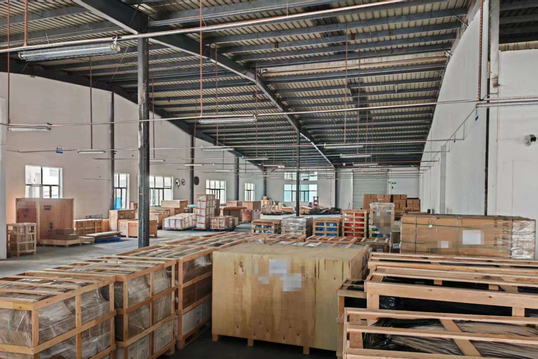 Packed building materials and furniture staged in an organized warehouse aisle